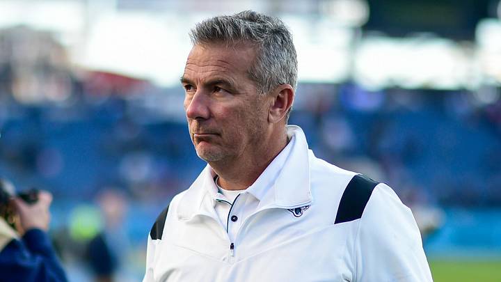 Dec 12, 2021; Nashville, Tennessee, USA;  Jacksonville Jaguars head coach Urban Meyer walks from the field after the game as quarterback Trevor Lawrence (16) follows against the Tennessee Titans at Nissan Stadium. Mandatory Credit: Steve Roberts-Imagn Images
