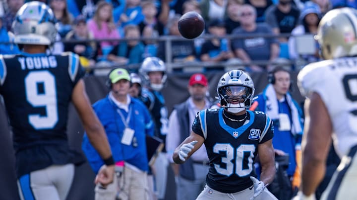 Nov 3, 2024; Charlotte, North Carolina, USA; Carolina Panthers running back Chuba Hubbard (30) gets a pass from quarterback Bryce Young (9) during the third quarter against the New Orleans Saints at Bank of America Stadium. 