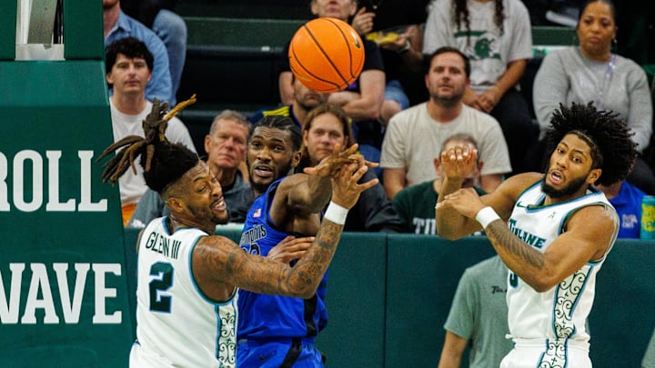 Jan 30, 2025; New Orleans, Louisiana, USA;  Memphis Tigers center Moussa Cisse (32) knocks the ball free from Tulane Green Wave forward Greg Glenn III (2) during the second half at Avron B. Fogelman Arena in Devlin Fieldhouse.
