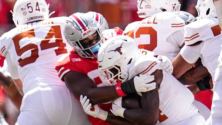 Ohio State Buckeyes defensive lineman Kayden McDonald (98) tackles Texas Longhorns running back CJ Baxter (4) during the NCAA football game at Ohio Stadium on Aug. 30, 2025.