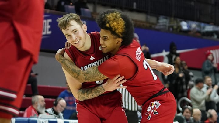 Jan 21, 2025; Dallas, Texas, USA; Louisville Cardinals guard Reyne Smith (6) is hugged by guard Chucky Hepburn (24) after a made three-point basket against the SMU Mustangs during the second half at Moody Coliseum. Mandatory Credit: Raymond Carlin III-Imagn Images