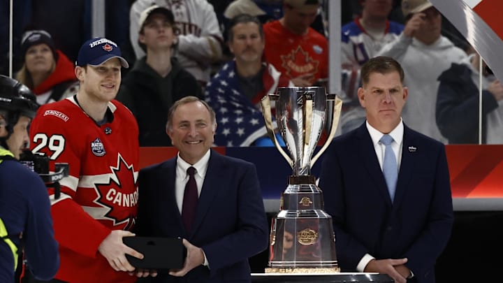 Feb 20, 2025; Boston, MA, USA; [Imagn Images direct customers only]  Team Canada forward Nathan MacKinnon (29) receives the Most Valuable Player award from NHL commissioner Gary Bettman during the 4 Nations Face-Off ice hockey championship game at TD Garden. Mandatory Credit: Winslow Townson-Imagn Images