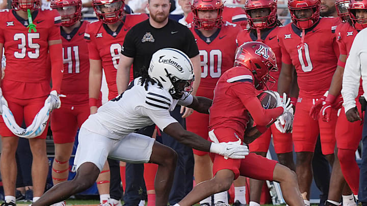 Arizona Wildcats wide receiver Kris Hutson (4) gets tackle by Iowa State Cyclones' defensive back Jontez Williams (3) after making a catch during the first quarter in the Big-12 conference showdown on Sept. 27, 2025, at Jack Trice Stadium in Ames, Iowa.
