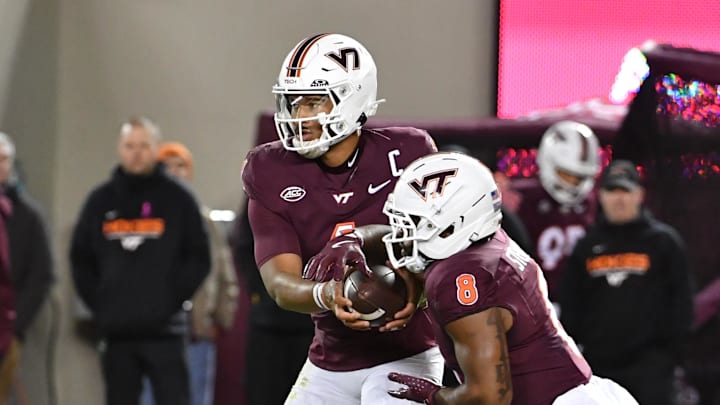 Oct 24, 2025; Blacksburg, Virginia, USA;  Virginia Tech Hokies quarterback Kyron Drones (1) hands the ball off to running back Terion Stewart (8) against the California Golden Bears during the first quarter at Lane Stadium. Mandatory Credit: Brian Bishop-Imagn Images