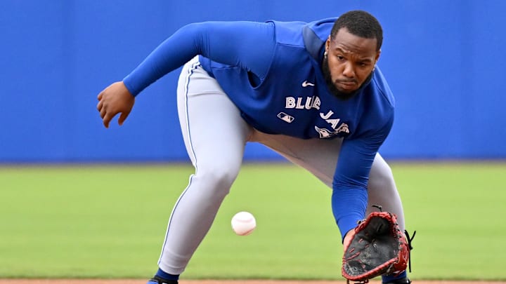 Feb 20, 2025; Dunedin, FL, USA; Toronto Blue Jays infielder Vladimir Guerrero Jr. (27) fields a ground ball during spring training  at Cecil B. Englebert Complex.  Mandatory Credit: Jonathan Dyer-Imagn Images