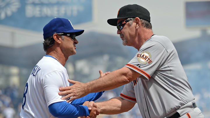Apr 4, 2014; Los Angeles, CA, USA; Los Angeles Dodgers manager Don Mattingly (8) shakes hands with San Francisco Giants manager Bruce Bochy (15) before the game at Dodger Stadium. Giants won 8-4. Mandatory Credit: Jayne Kamin-Oncea-Imagn Images
