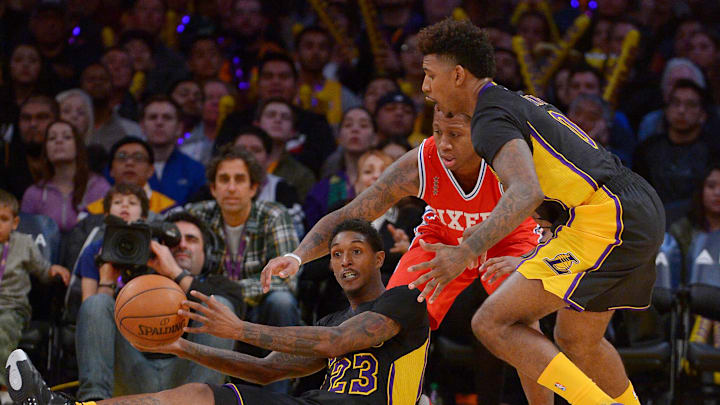 Jan 1, 2016; Los Angeles, CA, USA; Los Angeles Lakers guard Lou Williams (23) passes the ball to forward Nick Young (0) as Philadelphia 76ers guard Isaiah Canaan (0) defends in the second half of the game at Staples Center. Lakers won 93-84. Mandatory Credit: Jayne Kamin-Oncea-USA TODAY Sports Jan 1, 2016; Los Angeles, CA, USA; Los Angeles Lakers guard Lou Williams (23) passes the ball to forward Nick Young (0) as Philadelphia 76ers guard Isaiah Canaan (0) defends in the second half of the game at Staples Center. Lakers won 93-84. Mandatory Credit: Jayne Kamin-Oncea-USA TODAY Sports