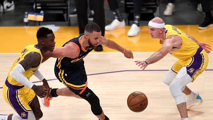 May 19, 2021; Los Angeles, California, USA;   Golden State Warriors guard Stephen Curry (30) gets past Los Angeles Lakers guard Dennis Schroder (17) and Los Angeles Lakers guard Alex Caruso (4) as he drives to the basket in the first half of the game at Staples Center. Mandatory Credit: Jayne Kamin-Oncea-Imagn Images