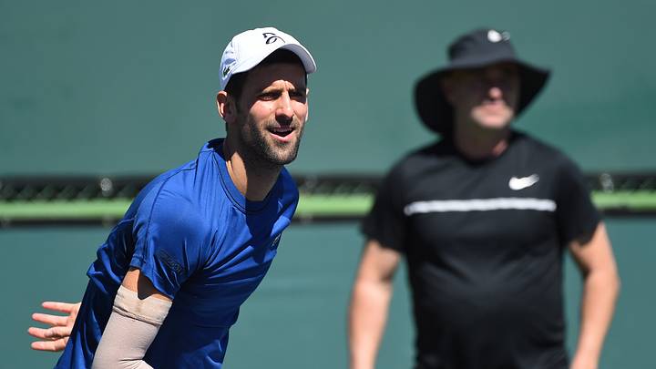 Mar 6, 2018; Indian Wells, CA, USA; Coach Andre Agassi (background) looks on as Novak Djokovic practices for the BNP Paribas Open at the Indian Wells Tennis Garden. Mandatory Credit: Jayne Kamin-Oncea-USA TODAY Sports