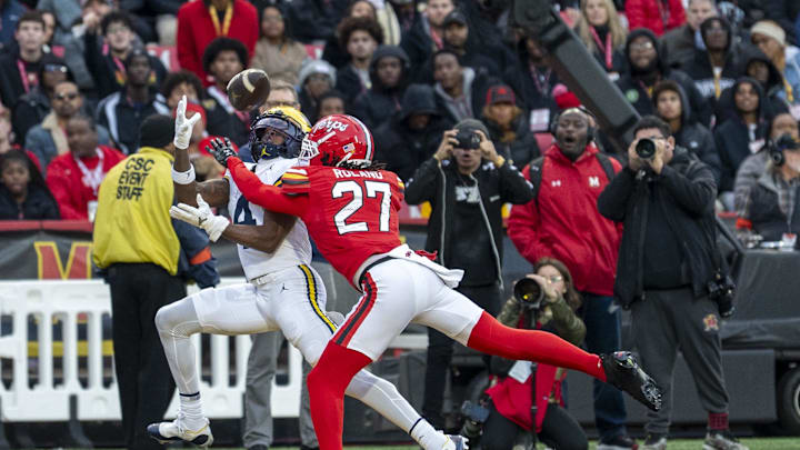 Nov 22, 2025; College Park, Maryland, USA; Michigan Wolverines wide receiver Andrew Marsh (4) catches a pass for a touchdown as Maryland Terrapins defensive back La'Khi Roland (27) defends during the first quarter  at SECU Stadium. Mandatory Credit: Tommy Gilligan-Imagn Images