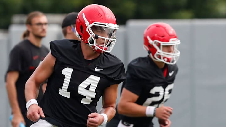 Georgia quarterback Gunner Stockton (14) looks on during the first day fall football camp in Athens, Ga., on Thursday, Aug. 3, 2023.