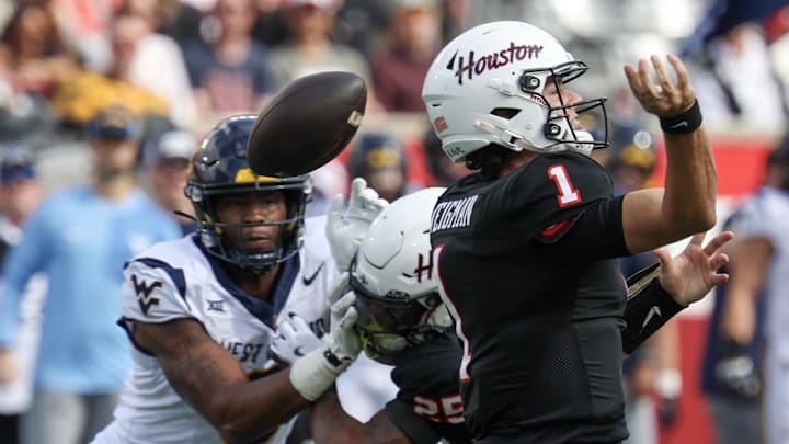 Nov 1, 2025; Houston, Texas, USA; Houston Cougars quarterback Conner Weigman (1) fumbles the ball against the West Virginia Mountaineers in the first half at TDECU Stadium. Mandatory Credit: Thomas Shea-Imagn Images Nov 1, 2025; Houston, Texas, USA; Houston Cougars quarterback Conner Weigman (1) fumbles the ball against the West Virginia Mountaineers in the first half at TDECU Stadium. Mandatory Credit: Thomas Shea-Imagn Images