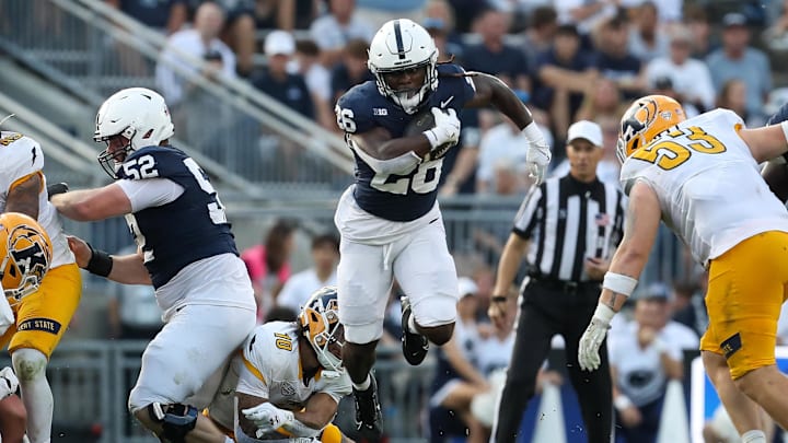 Penn State running back Cam Wallace leaps over Kent State linebacker Canaan Williams (10) during the third quarter at Beaver Stadium.