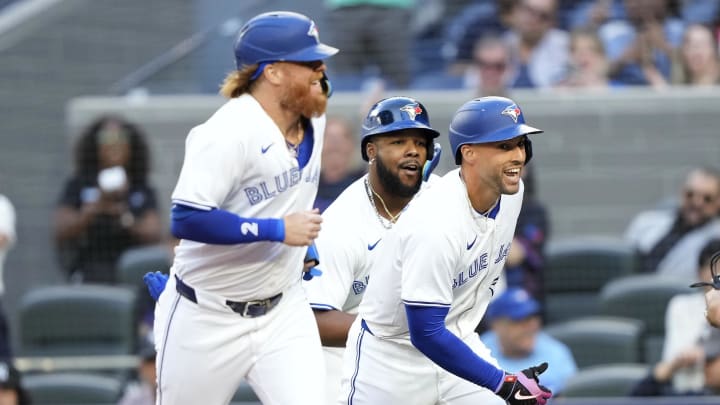 Jun 27, 2024; Toronto, Ontario, CAN; Toronto Blue Jays right fielder George Springer (right), designated hitter Justin Turner (2) and first baseman Vladimir Guerrero Jr. (center) celebrate at home plate after they scored on Springer's home run against the New York Yankees during the first inning at Rogers Centre. Mandatory Credit: John E. Sokolowski-USA TODAY Sports Jun 27, 2024; Toronto, Ontario, CAN; Toronto Blue Jays right fielder George Springer (right), designated hitter Justin Turner (2) and first baseman Vladimir Guerrero Jr. (center) celebrate at home plate after they scored on Springer's home run against the New York Yankees during the first inning at Rogers Centre. Mandatory Credit: John E. Sokolowski-USA TODAY Sports