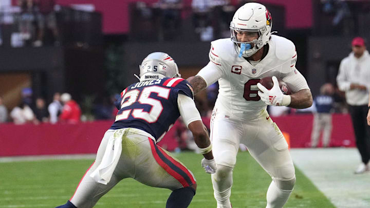 Arizona Cardinals running back James Conner (6) stiff arms New England Patriots cornerback Marcus Jones (25) at State Farm Stadium on Dec. 15, 2024. Arizona Cardinals running back James Conner (6) stiff arms New England Patriots cornerback Marcus Jones (25) at State Farm Stadium on Dec. 15, 2024.