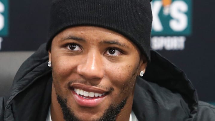 Eagles running back Saquon Barkley smiles for photos as he makes an autograph signing appearance.