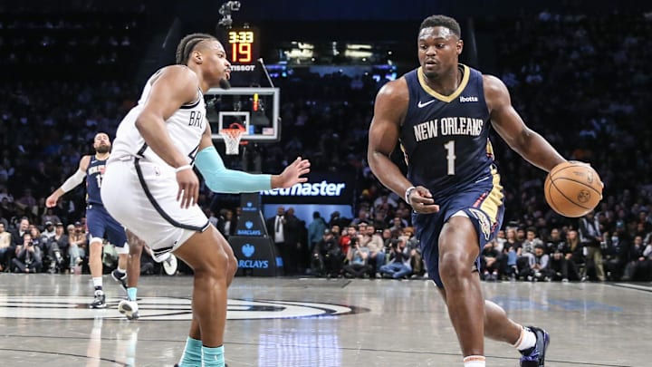Mar 19, 2024; Brooklyn, New York, USA;  New Orleans Pelicans forward Zion Williamson (1) looks to drive past Brooklyn Nets guard Dennis Smith Jr. (4) in the second quarter at Barclays Center. Mandatory Credit: Wendell Cruz-Imagn Images