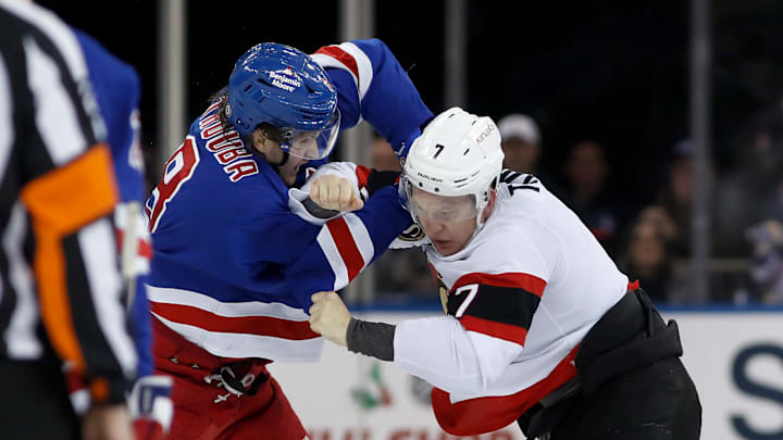 Brady Tkachuk and Jacob Trouba fight on the ice.