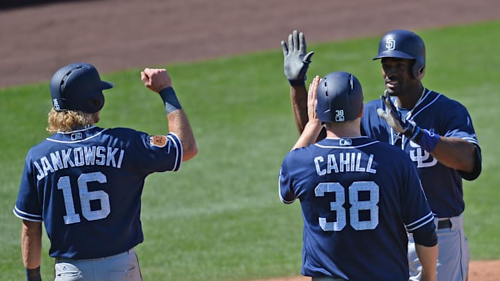 San Diego Padres right fielder Jabari Blash (32) slaps hands with San Diego Padres center fielder Travis Jankowski (16) and San Diego Padres starting pitcher Trevor Cahill (38) after hitting a grand slam against the Chicago Cubs during the fourth inning at Sloan Park on March 26, 2017.