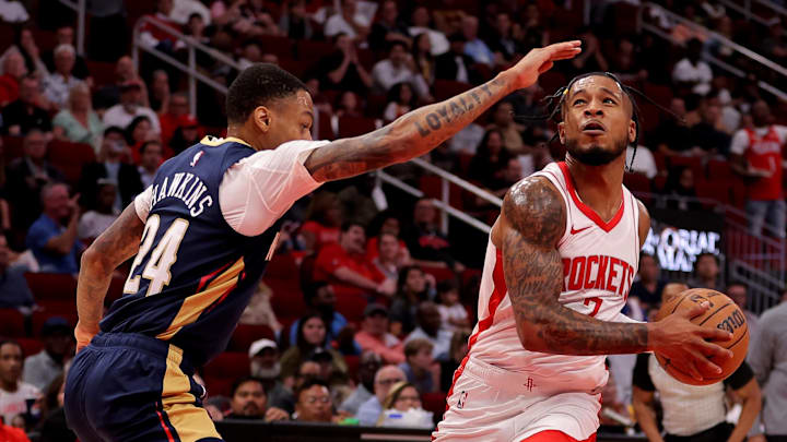 Oct 15, 2024; Houston, Texas, USA; Houston Rockets guard Cam Whitmore (7) drives to the basket against New Orleans Pelicans guard Jordan Hawkins (24) during the third quarter at Toyota Center. Mandatory Credit: Erik Williams-Imagn Images
