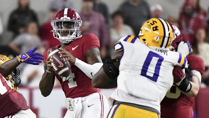 Nov 4, 2023; Tuscaloosa, Alabama, USA;  Alabama Crimson Tide quarterback Jalen Milroe (4) stands in the pocket under pressure from LSU at Bryant-Denny Stadium. Mandatory Credit: Gary Cosby Jr.-Imagn Images