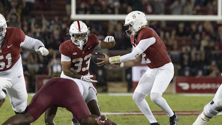 Oct 18, 2025; Stanford, California, USA;  Stanford Cardinal quarterback Elijah Brown (2) hands the ball off to Stanford Cardinal running back Cole Tabb (33) during the second quarter against the Florida State Seminoles at Stanford Stadium. Mandatory Credit: Stan Szeto-Imagn Images