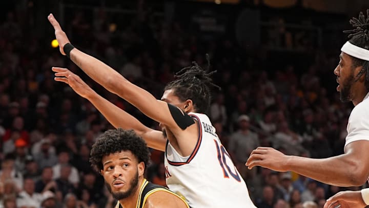 Mar 28, 2025; Atlanta, GA, USA; Michigan Wolverines guard Roddy Gayle Jr. (11) drives against Auburn Tigers guard Chad Baker-Mazara (10) in the first half of a South Regional semifinal of the 2025 NCAA tournament at State Farm Arena. Mandatory Credit: Dale Zanine-Imagn Images