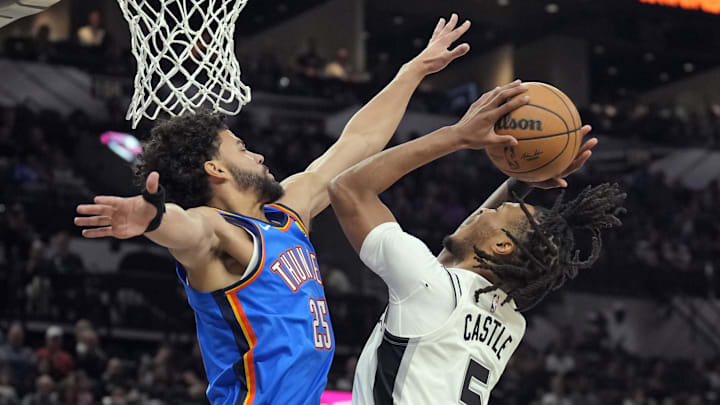 Oct 7, 2024; San Antonio, Texas, USA; San Antonio Spurs guard Stephon Castle (5) shoots over Oklahoma City Thunder guard Ajay Mitchell (25) during the first half at Frost Bank Center. Mandatory Credit: Scott Wachter-Imagn Images