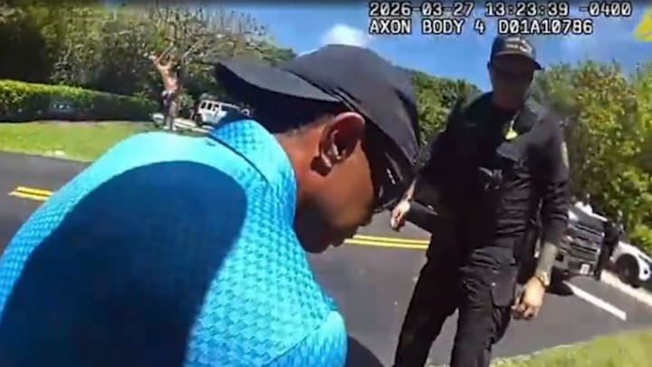 Tiger Woods on one knee talking to police. 