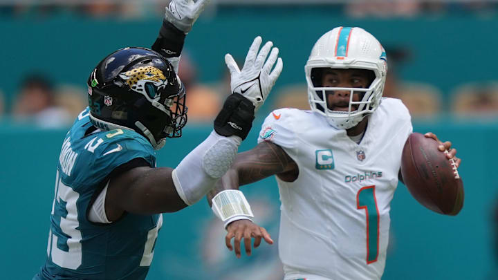Sep 8, 2024; Miami Gardens, Florida, USA;  Miami Dolphins quarterback Tua Tagovailoa (1) rolls out to pass as linebacker Foyesade Oluokun (23) follows on the play at Hard Rock Stadium.