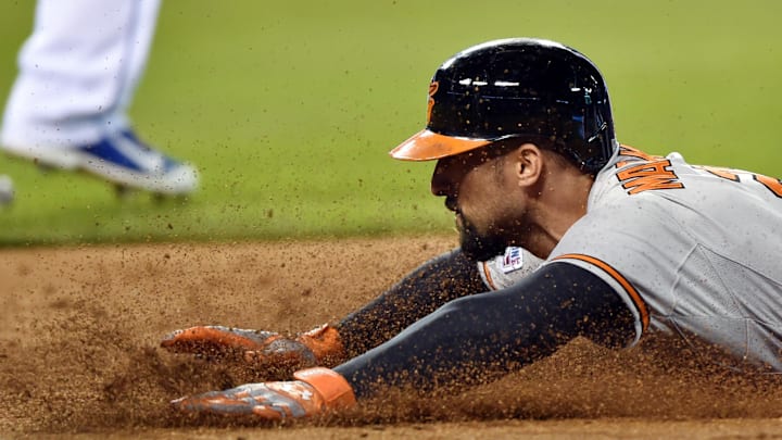 Oct 14, 2014; Kansas City, MO, USA; Baltimore Orioles right fielder Nick Markakis dives back to first base safely on a fielder's choice against the Kansas City Royals during the third inning in game three of the 2014 ALCS playoff baseball game at Kauffman Stadium. Mandatory Credit: Peter G. Aiken-Imagn Images