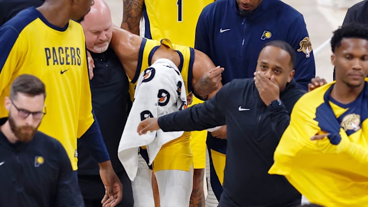 Jun 22, 2025; Oklahoma City, Oklahoma, USA; Indiana Pacers guard Tyrese Haliburton (0) is assisted after an apparent injury following a play against the Oklahoma City Thunder during the first half of game seven of the 2025 NBA Finals at Paycom Center. Mandatory Credit: Alonzo Adams-Imagn Images Jun 22, 2025; Oklahoma City, Oklahoma, USA; Indiana Pacers guard Tyrese Haliburton (0) is assisted after an apparent injury following a play against the Oklahoma City Thunder during the first half of game seven of the 2025 NBA Finals at Paycom Center. Mandatory Credit: Alonzo Adams-Imagn Images