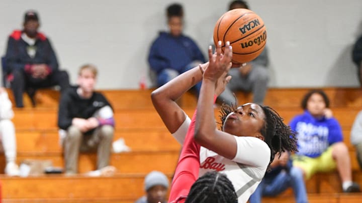 Erynn Moffett of Palm Bay shoots over Mia Burns and Princess Hardin of Dunnellon in the Class 4A girls basketball regional semifinal Monday, February 19, 2024. Craig Bailey/FLORIDA TODAY via USA TODAY NETWORK