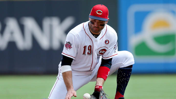 Cincinnati Reds first baseman Joey Votto (19) knocks down a groundzall in the sixth inning of an MLB baseball game against the Milwaukee Brewers, Thursday, July 4, 2019, at Great American Ball Park in Cincinnati.
