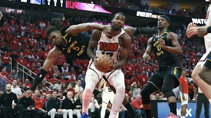 May 4, 2025; Houston, Texas, USA; Golden State Warriors forward Kevon Looney (5) falls to the ground as Houston Rockets forward Tari Eason (17) attempts to score during the third quarter of game seven of the first round for the 2025 NBA Playoffs at Toyota Center. Mandatory Credit: Troy Taormina-Imagn Images
