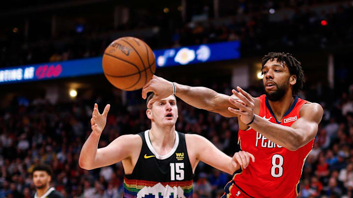 Dec 25, 2019; Denver, Colorado, USA; New Orleans Pelicans center Jahlil Okafor (8) passes the ball as Denver Nuggets center Nikola Jokic (15) defends in the third quarter at the Pepsi Center. Mandatory Credit: Isaiah J. Downing-Imagn Images