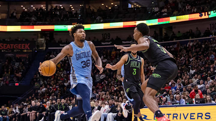 Dec 26, 2023; New Orleans, Louisiana, USA; Memphis Grizzlies guard Marcus Smart (36) drives to the basket against New Orleans Pelicans forward Herbert Jones (5) during the second half at Smoothie King Center. Mandatory Credit: Stephen Lew-Imagn Images