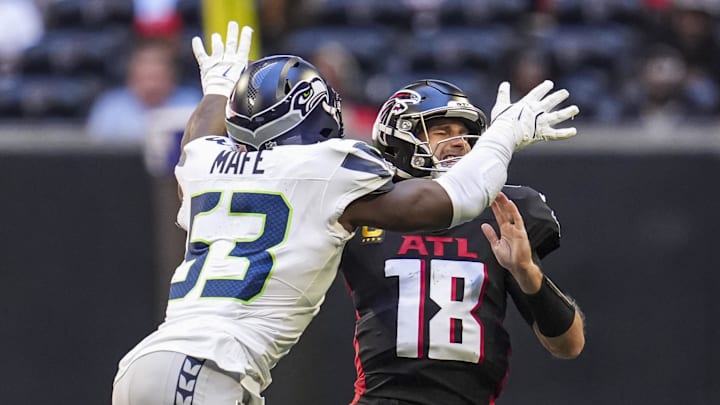 Oct 20, 2024; Atlanta, Georgia, USA; Seattle Seahawks linebacker Boye Mafe (53) hits Atlanta Falcons quarterback Kirk Cousins (18) causing a fumble that is returned for a Seahawks touchdown during the second half at Mercedes-Benz Stadium. Mandatory Credit: Dale Zanine-Imagn Images