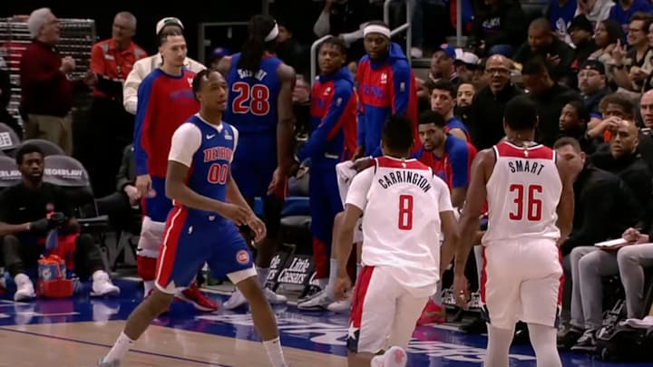 Ron Holland and Bub Carrington try to stop Marcus Smart from doing something foolish.