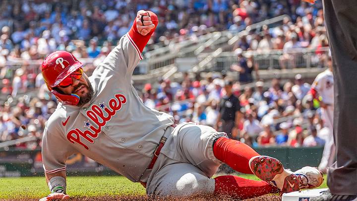 Sep 13, 2026; Cumberland, Georgia, USA; Philadelphia Phillies designated hitter Kyle Schwarber (12) slides into third base against the Atlanta Braves at Truist Park. Mandatory Credit: Dale Zanine-Imagn Images