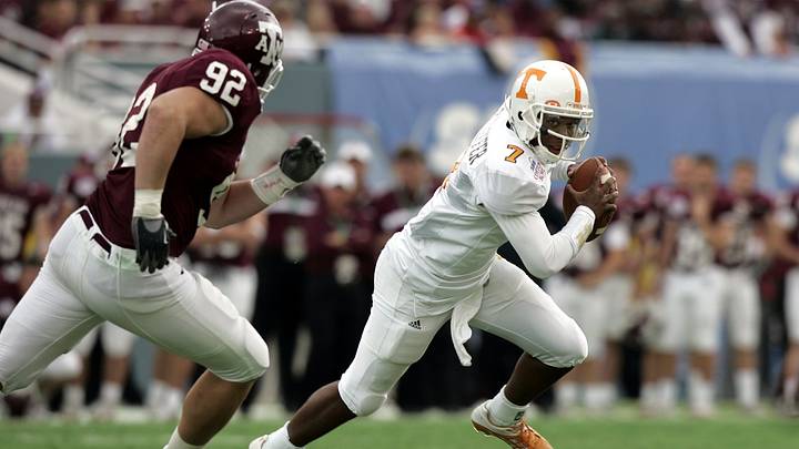 Tennessee's Brent Schaeffer runs out of the pocket as Texas A&M's Chris Harrington pursues during the Cotton Bowl on Jan. 1, 2005 in Dallas. The Vols won 38-7.
0101uttex13 Cc Tennessee's Brent Schaeffer runs out of the pocket as Texas A&M's Chris Harrington pursues during the Cotton Bowl on Jan. 1, 2005 in Dallas. The Vols won 38-7.
0101uttex13 Cc