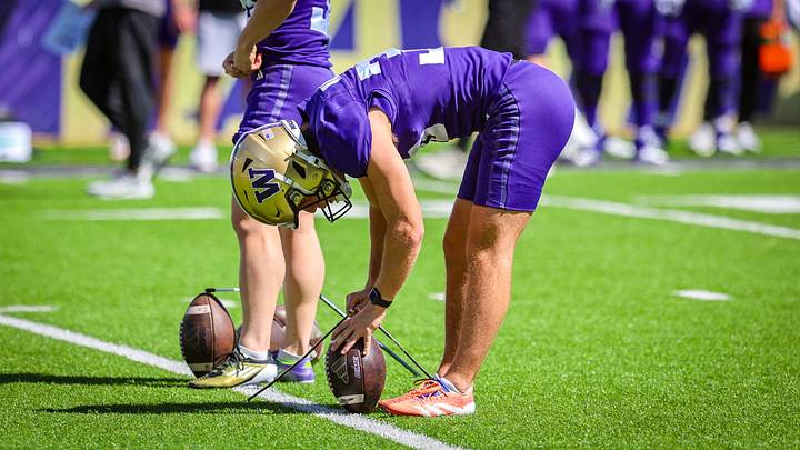 CJ Wallace sets up a kick on a tee at spring ball. CJ Wallace sets up a kick on a tee at spring ball.
