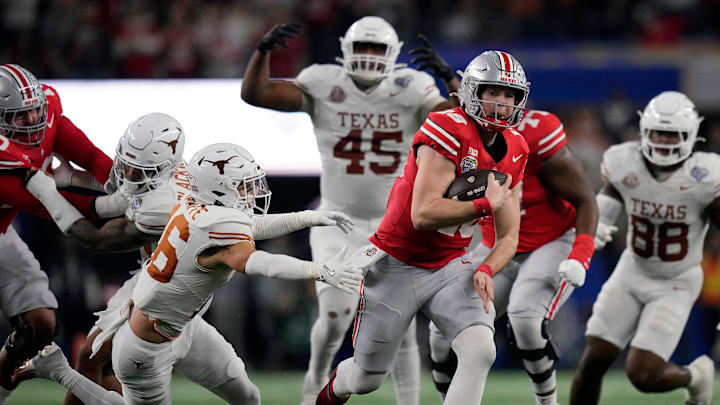 Ohio State Buckeyes quarterback Will Howard (18) runs past Texas Longhorns defensive back Michael Taaffe (16) for a first down on fourth down against Texas Longhorns in the fourth quarter of the Cotton Bowl Classic during the College Football Playoff semifinal game at AT&T Stadium in Arlington, Texas on January, 10, 2025.