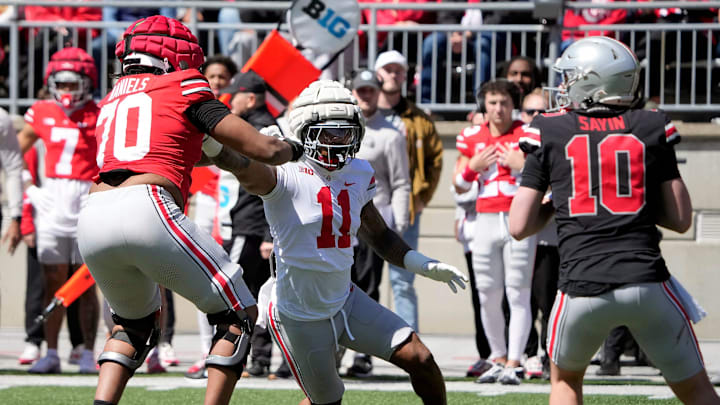 Ohio State Buckeye Gary C.J. Hicks (11) goes up against Scarlet Phillip Daniels (70) during the 1st half of the spring game at Ohio Stadium on April 12, 2025.
