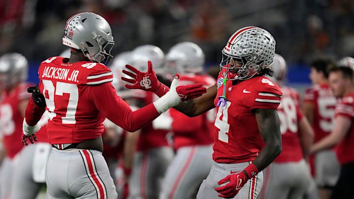 Ohio State Buckeyes defensive end Kenyatta Jackson Jr. (97) and Ohio State Buckeyes wide receiver Jeremiah Smith (4) do a hand shake during final warm ups at the Cotton Bowl Classic before their game against Texas Longhorns in the College Football Playoff semifinal game at AT&T Stadium in Arlington, Texas on January, 10, 2025.