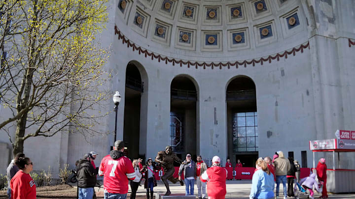 Ohio State Buckeye fans get their pictures taken around the Archie Griffin statue outside Ohio Stadium before the spring game on April 12, 2025.