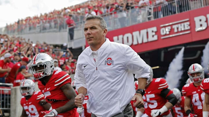 Urban Meyer, here leading Ohio State on the field in a 2016 game, coached the Buckeyes to an 83-9 record in seven seasons.