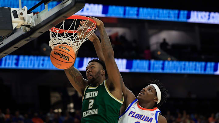 South Florida Bulls forward Jamille Reynolds (2) dunks on Florida Gators center Rueben Chinyelu (9) during the second half of an NCAA men’s basketball matchup Monday, Nov. 4, 2024 at VyStar Veterans Memorial Arena in Jacksonville, Fla. Florida defeated South Florida 98-83. [Corey Perrine/Florida Times-Union]