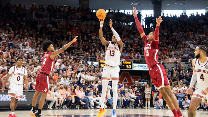 Auburn Tigers guard Miles Kelly (13) takes a jump shot as Auburn Tigers take on Alabama Crimson Tide at Neville Arena in Auburn, Ala., on Saturday, March 8, 2025. Alabama Crimson Tide defeated Auburn Tigers 93-91.