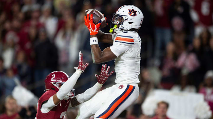 Auburn Tigers wide receiver Cam Coleman (8) catches a touchdown pass over Alabama Crimson Tide defensive back Zabien Brown (2) 